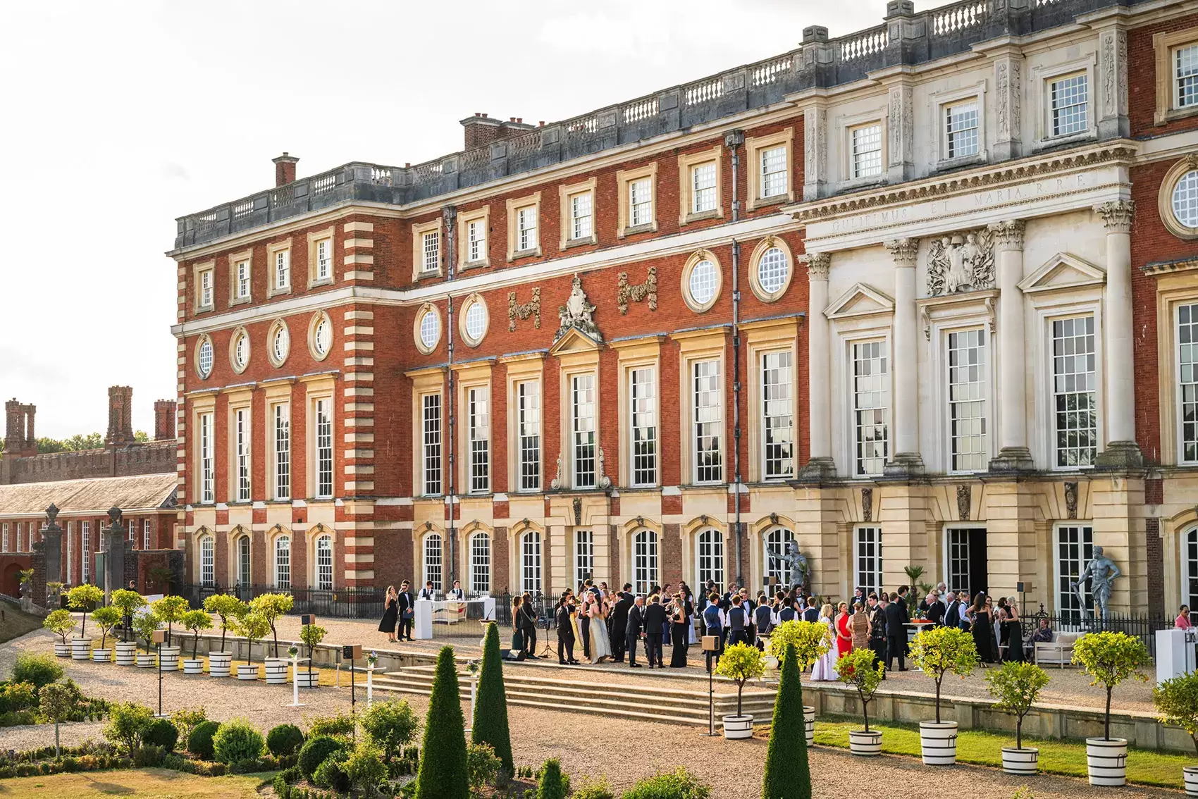 Guests in a courtyard at Hampton Court Palace